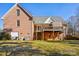 Back exterior with a brick facade, a spacious yard and a wooden deck with awning at 912 Silver Charm Ln, York, SC 29745
