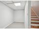 Finished basement with carpeted floor and bright overhead lighting near wooden stairs at 912 Silver Charm Ln, York, SC 29745