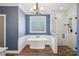 Beautiful bathroom with a soaking tub, glass enclosed shower, bright blue walls and white trim at 912 Silver Charm Ln, York, SC 29745
