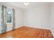 Bedroom with hardwood floors, a window, neutral paint, and white trim at 912 Silver Charm Ln, York, SC 29745