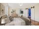 Staged bedroom featuring neutral walls, soft lighting, a cozy bed, and barn doors to the ensuite at 912 Silver Charm Ln, York, SC 29745