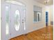 Elegant foyer featuring a decorative glass front door and gleaming hardwood floors, offering a warm welcome at 912 Silver Charm Ln, York, SC 29745