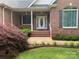 Charming front entrance features a detailed glass door and a beautifully landscaped yard at 912 Silver Charm Ln, York, SC 29745