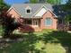 Charming brick home featuring a well-manicured lawn, mature landscaping, and a welcoming front entrance at 912 Silver Charm Ln, York, SC 29745