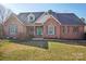 Traditional brick home with a tidy lawn, dormer windows, and an inviting covered front porch at 912 Silver Charm Ln, York, SC 29745