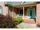 Inviting brick home featuring a lovely blue front door, covered porch, and well-maintained landscaping at 912 Silver Charm Ln, York, SC 29745