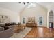 Staged living room with vaulted ceiling, hardwood floors, and abundant natural light at 912 Silver Charm Ln, York, SC 29745