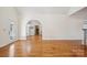 Large open living space featuring hardwood floors, neutral walls, and an arched doorway at 912 Silver Charm Ln, York, SC 29745