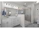 Modern bathroom with double sinks, a large mirror, and a glass-enclosed shower at 9804 Ainslie Downs St, Charlotte, NC 28273