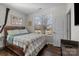 Cozy bedroom with a comfortable bed, hardwood floors, and a window view at 9804 Ainslie Downs St, Charlotte, NC 28273