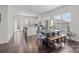Bright dining area with hardwood floors, modern furnishings, and ample natural light, open to the kitchen at 9804 Ainslie Downs St, Charlotte, NC 28273