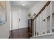 Inviting entryway featuring modern decor, a black cabinet and staircase with carpeted steps and wooden railing at 9804 Ainslie Downs St, Charlotte, NC 28273