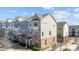 Charming multi-story townhome with brick and siding exterior, complemented by manicured landscaping and sunny skies at 9804 Ainslie Downs St, Charlotte, NC 28273
