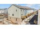 View of multi-story townhome with private garage, complimented by wood decks and brick facade at 9804 Ainslie Downs St, Charlotte, NC 28273