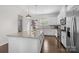 Modern kitchen featuring granite countertops, stainless steel appliances, white cabinets and a spacious island at 9804 Ainslie Downs St, Charlotte, NC 28273