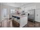 Modern kitchen with stainless steel appliances, granite countertops, island with seating, and ample cabinet space at 9804 Ainslie Downs St, Charlotte, NC 28273