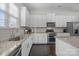 Well-lit kitchen featuring granite countertops, stainless steel appliances, white cabinets and a double oven at 9804 Ainslie Downs St, Charlotte, NC 28273