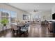 Spacious living room with large windows, hardwood floors, comfortable seating, and ample natural light at 9804 Ainslie Downs St, Charlotte, NC 28273