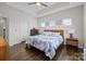 Bright main bedroom featuring hardwood floors, tray ceilings, and a comfortable bed at 9804 Ainslie Downs St, Charlotte, NC 28273