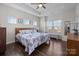 Comfortable main bedroom with tray ceilings, hardwood floors, and ample natural light at 9804 Ainslie Downs St, Charlotte, NC 28273