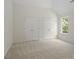 Light-filled bedroom with two closets, a window with green leafy views, and light-colored carpeting at 10032 Montrose Nw Dr, Charlotte, NC 28269