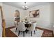 Formal dining room featuring a round table set for six, complemented by elegant decor and wainscoting at 10032 Montrose Nw Dr, Charlotte, NC 28269