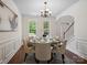 Stylish dining room featuring a round table set for six, elegant decor, and natural light at 10032 Montrose Nw Dr, Charlotte, NC 28269