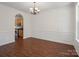 Elegant dining room with hardwood floors, crown molding, and view into the kitchen at 10032 Montrose Nw Dr, Charlotte, NC 28269