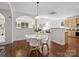 Bright dining area with hardwood floors open to the kitchen and living room at 10032 Montrose Nw Dr, Charlotte, NC 28269