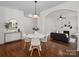 Open-concept dining area with hardwood floors leading to living area at 10032 Montrose Nw Dr, Charlotte, NC 28269