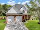 Beautiful two-story brick and siding home with a two-car garage and inviting front yard landscaping at 10032 Montrose Nw Dr, Charlotte, NC 28269