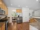 Well-lit kitchen featuring stainless steel appliances, wooden cabinetry, and granite countertops at 10032 Montrose Nw Dr, Charlotte, NC 28269