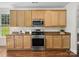 Bright kitchen with wood cabinets, stainless steel appliances, and ample counter space at 10032 Montrose Nw Dr, Charlotte, NC 28269
