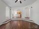 Open-concept living room with hardwood floors and arched doorways leading to other rooms at 10032 Montrose Nw Dr, Charlotte, NC 28269