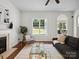 Bright living room featuring hardwood floors and fireplace at 10032 Montrose Nw Dr, Charlotte, NC 28269