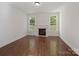 Bright living room with a fireplace and large windows, offering a cozy and inviting space at 10032 Montrose Nw Dr, Charlotte, NC 28269