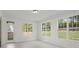 Sunlit room with tile floors, multiple windows, and a door to the outside at 10032 Montrose Nw Dr, Charlotte, NC 28269