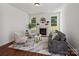 Bright living room with fireplace, light gray seating and hardwood floors at 10032 Montrose Nw Dr, Charlotte, NC 28269