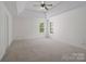 Spacious main bedroom with large windows and plush carpeting at 10032 Montrose Nw Dr, Charlotte, NC 28269