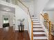 Elegant staircase featuring wooden treads and white risers, complemented by a stylish table with flowers at 10032 Montrose Nw Dr, Charlotte, NC 28269