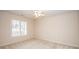 This bedroom has carpet, a ceiling fan, and a window with blinds for natural light at 10034 Bishops Gate Blvd, Pineville, NC 28134