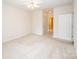Spacious bedroom with neutral carpet, ceiling fan, and access to two doors at 10034 Bishops Gate Blvd, Pineville, NC 28134