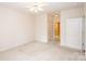 Spacious bedroom with neutral carpet, ceiling fan, and two doors at 10034 Bishops Gate Blvd, Pineville, NC 28134