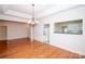 Bright dining room features hardwood floors and a pass-through to the kitchen at 10034 Bishops Gate Blvd, Pineville, NC 28134