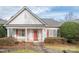 Charming single-story home with a well-manicured lawn, red door, white siding, and inviting front porch at 10034 Bishops Gate Blvd, Pineville, NC 28134