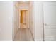 Carpeted hallway with three doors and neutral paint, providing a cohesive design at 10034 Bishops Gate Blvd, Pineville, NC 28134