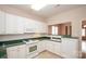 Classic kitchen with white cabinets, green counters, and modern appliances at 10034 Bishops Gate Blvd, Pineville, NC 28134