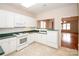 Cozy kitchen featuring white appliances, green countertops, and a view to the living room at 10034 Bishops Gate Blvd, Pineville, NC 28134