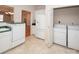Bright laundry area with a washing machine and dryer next to the kitchen at 10034 Bishops Gate Blvd, Pineville, NC 28134