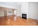 Bright, open living room with gleaming hardwood floors, columns, and a cozy fireplace at 10034 Bishops Gate Blvd, Pineville, NC 28134